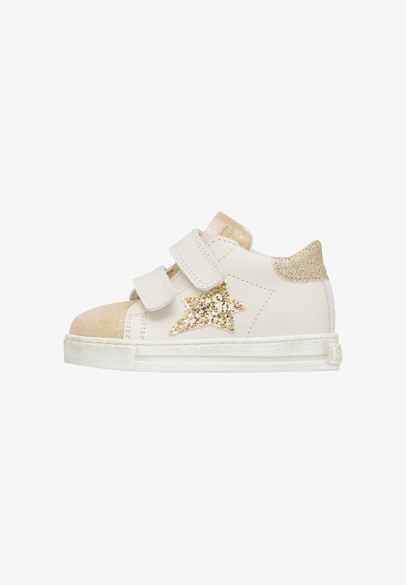 White leather athletic shoe with a tan suede toe cap, gold star glitter detail, and two Velcro straps, featuring a textured outsole.