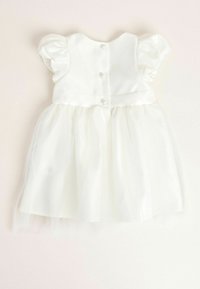 White dress with short puff sleeves, satin bodice, and a tulle skirt. Back features five decorative buttons for closure.