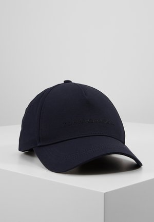 Gorra de béisbol Tommy Hilfiger en azul marino con visera curva, costuras minimalistas y emblema con texto de la marca en el panel frontal.