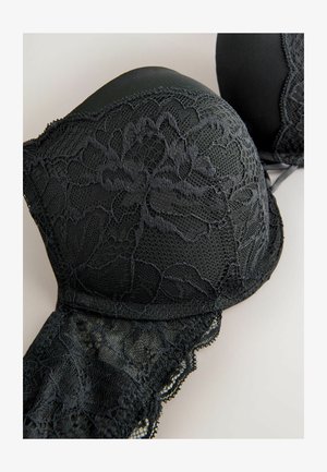 Sort blondel med formede skåle, prydet med blomster mønstre og bølgede kanter. Stoffet kombinerer blonde og uigennemsigtige materialer.