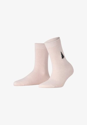 Hellrosa Socken aus weichem Stoff mit einem gerippten Bund und einer schwarzen Baumsilhouette an der Seite. Knöchelhohes Design.