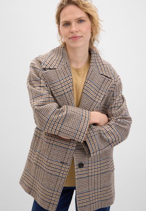 Brown plaid jacket with oversized fit, notched lapels, and two buttons. The fabric features a textured weave and contrasting blue and yellow lines.