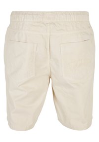 Beige bomuldsshorts med elastisk talje, med to baglommer og prægede "SOUTHPONT"-mærkning på den højre lomme.