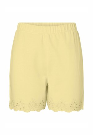 Lysegule dameshorts med elastisk talje og bølget kant med blomsterbroderi med hulmønster.