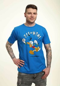 Blue cotton t-shirt featuring an animated character in motion. Graphic includes colorful text and illustrations in black and yellow accents.