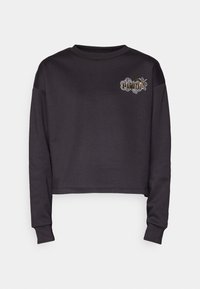 Sweatshirt gris foncé raccourci en tissu doux. Caractérisé par des manches longues, un col rond et un motif brodé sur la poitrine.