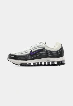 Nike Air Max sneaker featuring a white mesh upper, black accents, purple logo, curved design, and visible air cushioning at the sole.