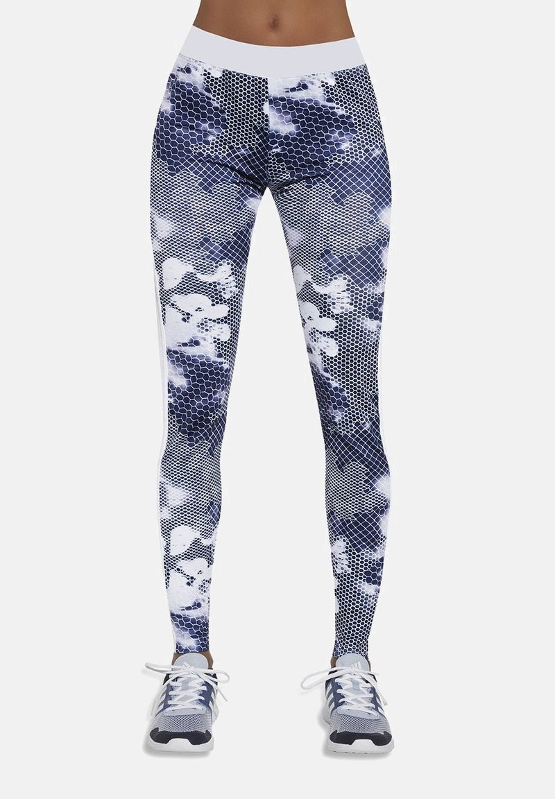 Legginsy w granatowo-białym kolorze z geometrycznym wzorem, zawierającym heksagonalne kształty i abstrakcyjne wzory. Gładki, elastyczny materiał.