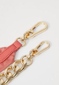 Pink textured strap with gold hardware featuring two snap hooks and a chunky gold chain link, showcasing a metallic finish.
