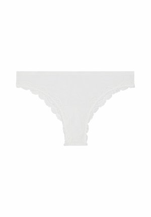 White lace thong with scalloped edges, made of a soft fabric. Features delicate lace trim along the waist and leg openings.