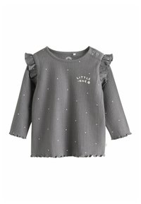 Top de manga larga gris con acentos de volantes, detalles de lunares blancos y bordado "LITTLE ONE". Dobladillo y escote con forma de ondas.