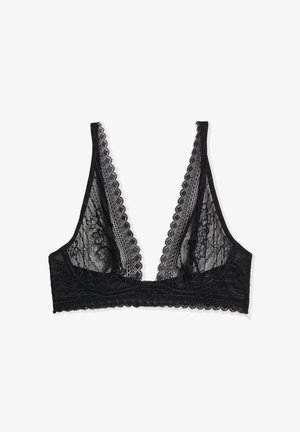 Bralette en dentelle noire avec décolleté en V profond, bords festonnés, motif en dentelle florale et large bande élastique sous la poitrine sur fond blanc.