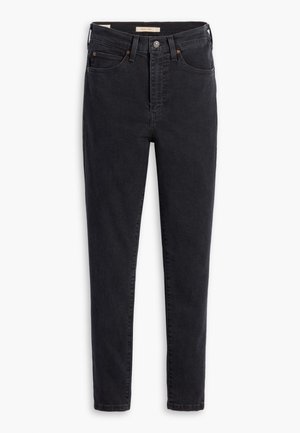 Schwarze Denim-Jeans mit hoher Taille, schmaler Passform und minimalen Nähdetails. Der Stoff zeigt eine leichte Textur mit einer glatten Oberfläche.