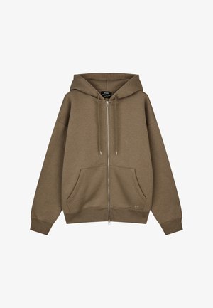 Brauner Kapuzenpullover mit Reißverschluss, Fronttaschen, Kordelzugkapuze, gerippten Bündchen und Saum sowie einem kleinen "MN"-Logo auf der Tasche.