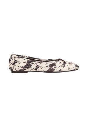 Black and white spotted ballet flat with a small bow on the rounded toe and low heel, shown from the side on a white background.