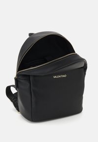 Black leather backpack with a textured finish, zip closure, and gold hardware. Features the brand name "Valentino" on the front.