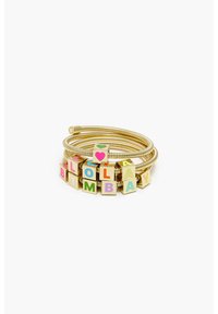 Gold-tone metal bracelet featuring colorful letter blocks spelling "LOLABIMBAAA" with a heart design, set on a flexible coiled band.