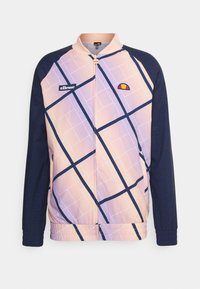 Trekkjakke med et rosa og marineblått rutemønster, med høy krage, glidelås og logo på brystet. Stoffet er glatt og lett.