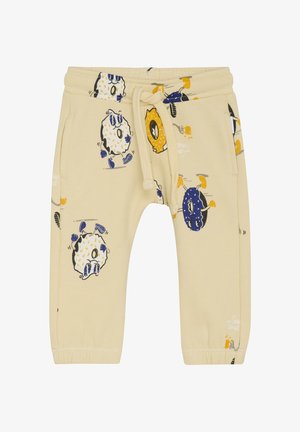 Lichtbeige sweatpants met speelse patronen van dieren en voedsel. Voorzien van een elastische tailleband met een trekkoord, zijzakken en omgeslagen enkels.