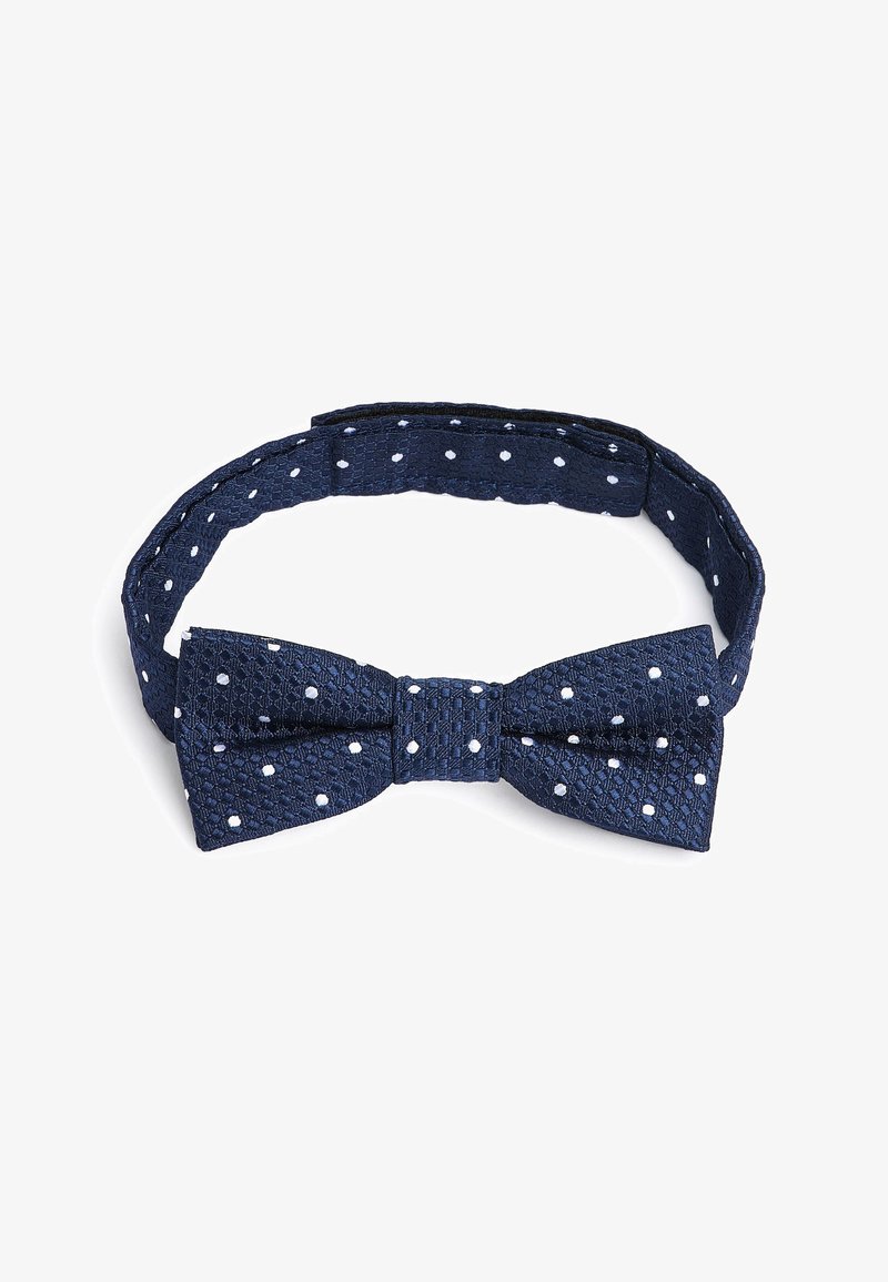 Tamno plavi teksturirani leptir mašna s bijelim točkicama, koja ima podesivu traku za sigurno prianjanje i strukturirani oblik mašne.