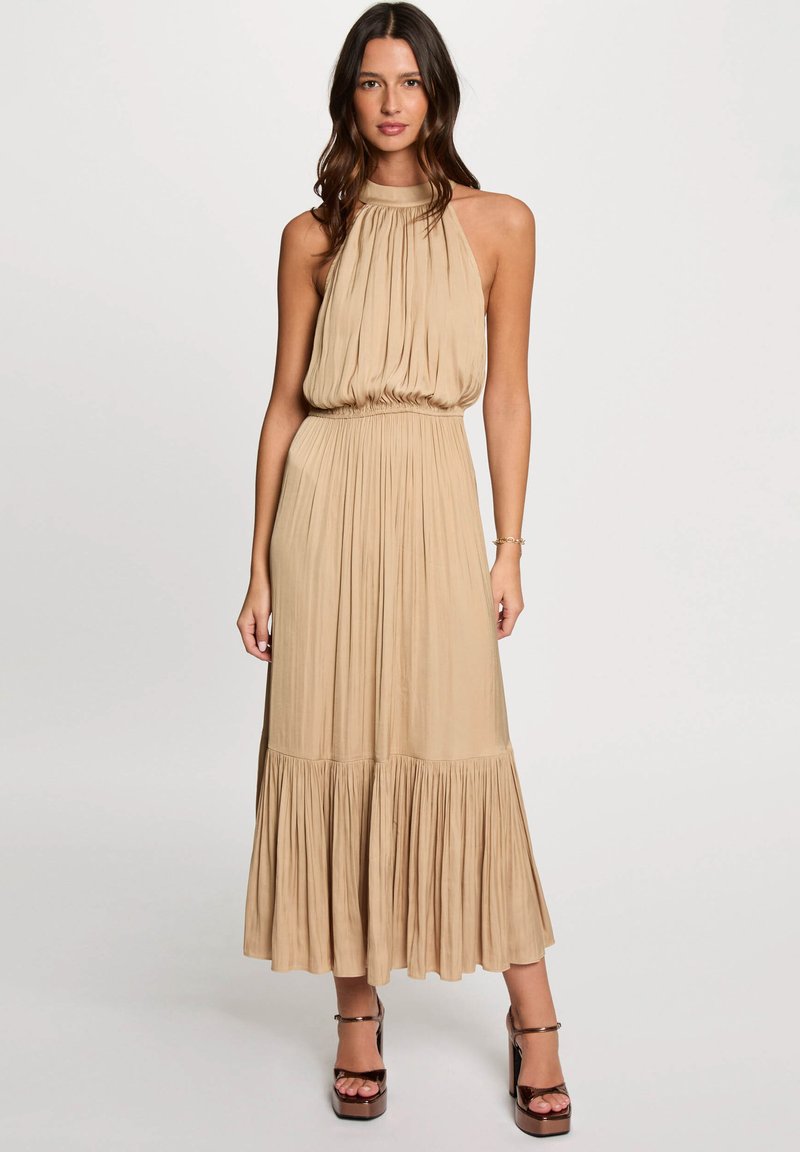Beige halter maxi dress with gathered bodice and tiered ruffle hem, made of soft material, featuring a fitted waist and flowing skirt.