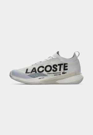 Lacoste sneaker features a lightweight, white mesh upper with black branding, curved sole, and LSRFOAM cushioning. Accents in light grey.
