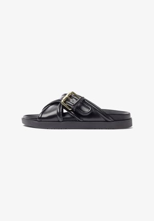 Black leather slide sandal featuring a thick sole, cross-strap design, and a gold-tone buckle accent. Textured material with a smooth finish.