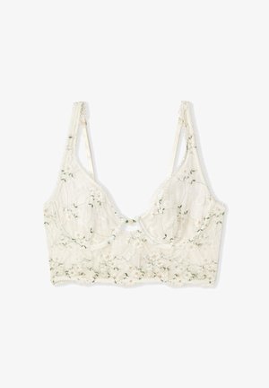 Weißer Spitzen-Bralette mit floraler Stickerei, verstellbaren Trägern, Bügel-Cups und einer kleinen dekorativen Schleife vorne in der Mitte.