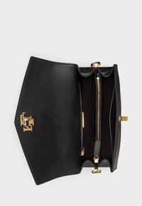 Black leather handbag with a smooth texture, gold hardware, a zipper compartment, and a clasp closure. Interior features multiple sections.