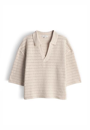 Beige knitted short-sleeve sweater with a deep V-neck and collar, featuring a textured, open-weave pattern.