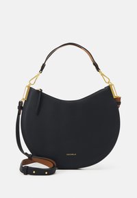 Unselected, noir/cuir