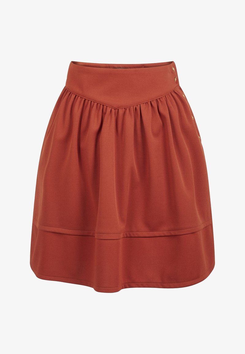Jupe longueur genou couleur rouille avec une large ceinture et des plis décoratifs, dotée de boutons dorés sur le côté.