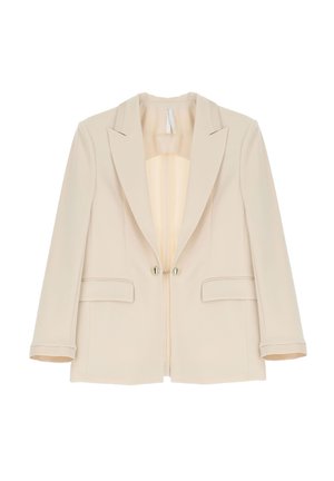 Blazer beige su misura con colletto, due tasche frontali e due bottoni metallici. Tessuto liscio con interno foderato.