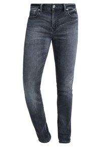 Jeans ajustados de color gris oscuro con detalles de decoloración, bolsillos frontales, trabillas para cinturón y cierre de botón.
