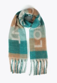 Tealová a béžová kostkovaná šála vyrobená z jemné látky, s třásněmi na koncích a výrazným bílým nápisem napříč designem.