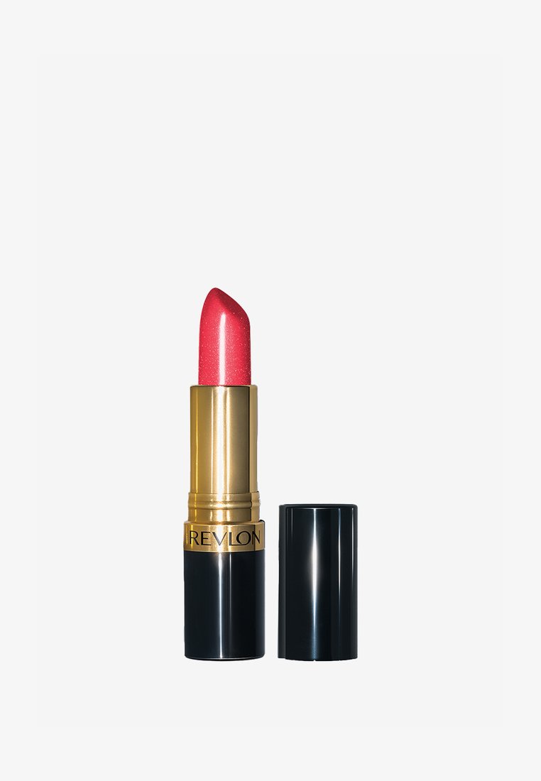 Rouge à lèvres Revlon rose scintillant avec boîtier doré et noir, posé à côté d’un capuchon noir retiré sur fond blanc.