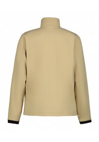 Beige jacka med hög krage, långa ärmar och svart kantning vid ärmsluten. Slät textur med en enkel, odekorerad design.