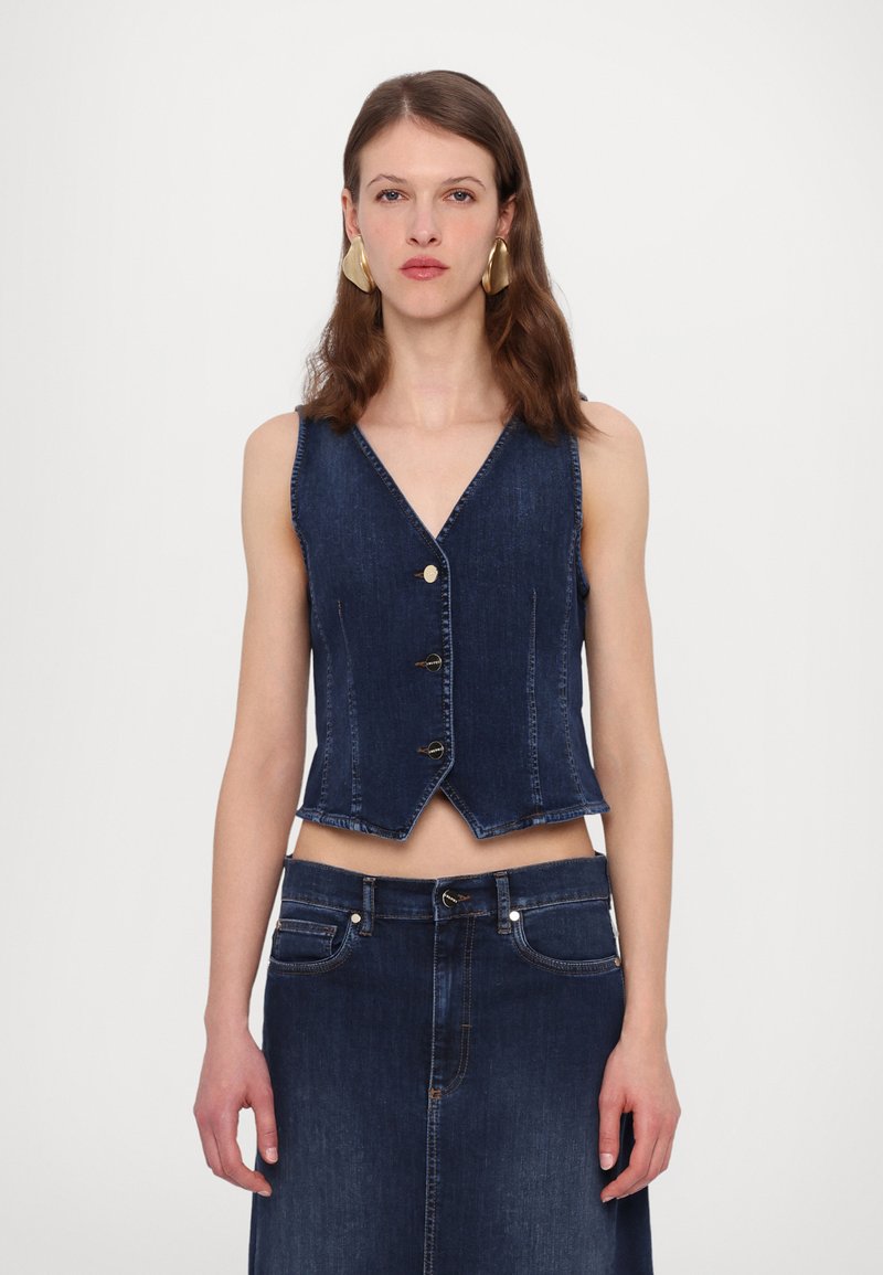 Dark blue denim vest with a V-neck, front buttons, and a cropped design, featuring a slightly frayed hem and a fitted silhouette.