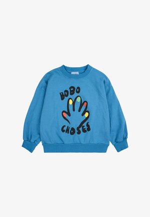 Felpa blu a maniche lunghe. Presenta una grafica nera di una mano e il testo "BOBO CHOSE" in grassetto. Polsini e vita a coste. Materiale in cotone.