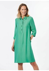 Grünes, knöpfbares Kleid mit Kragen, Dreiviertelärmeln und lockerer Passform. Hergestellt aus einem glatten, leichten Stoff mit einer dezenten Textur.