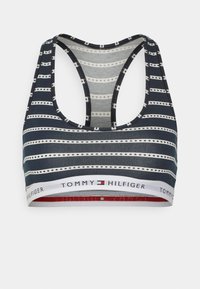 Soutien-gorge de sport rayé avec des rayures horizontales bleu marine et blanches, des accents rouges et une bande de logo avec "TOMMY HILFIGER" en bas.