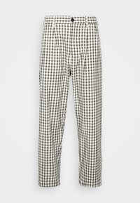 White pants with black and olive green plaid pattern, button and zipper closure, belt loops, and straight-leg fit.