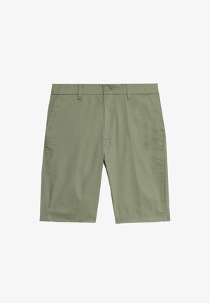 Pantalones cortos verde claro hechos de una tela suave, con cierre de botón, trabillas para el cinturón, bolsillos laterales y un diseño de corte relajado.