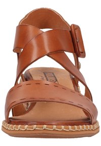 Brown leather sandal with crossover straps, a side buckle, and stitching detail. Soft footbed and braided accent on the sole edge.