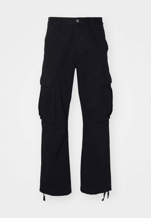 Black cargo pants made of cotton, featuring two large side pockets, drawstring hems, and a straight-leg design.