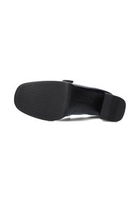 Black shoe sole with a textured surface and slight heel. Features a smooth, glossy finish with subtle logo detail near the heel.