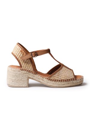 Women’s tan woven wedge sandal with ankle strap and buckle, open toe, and braided jute platform heel.