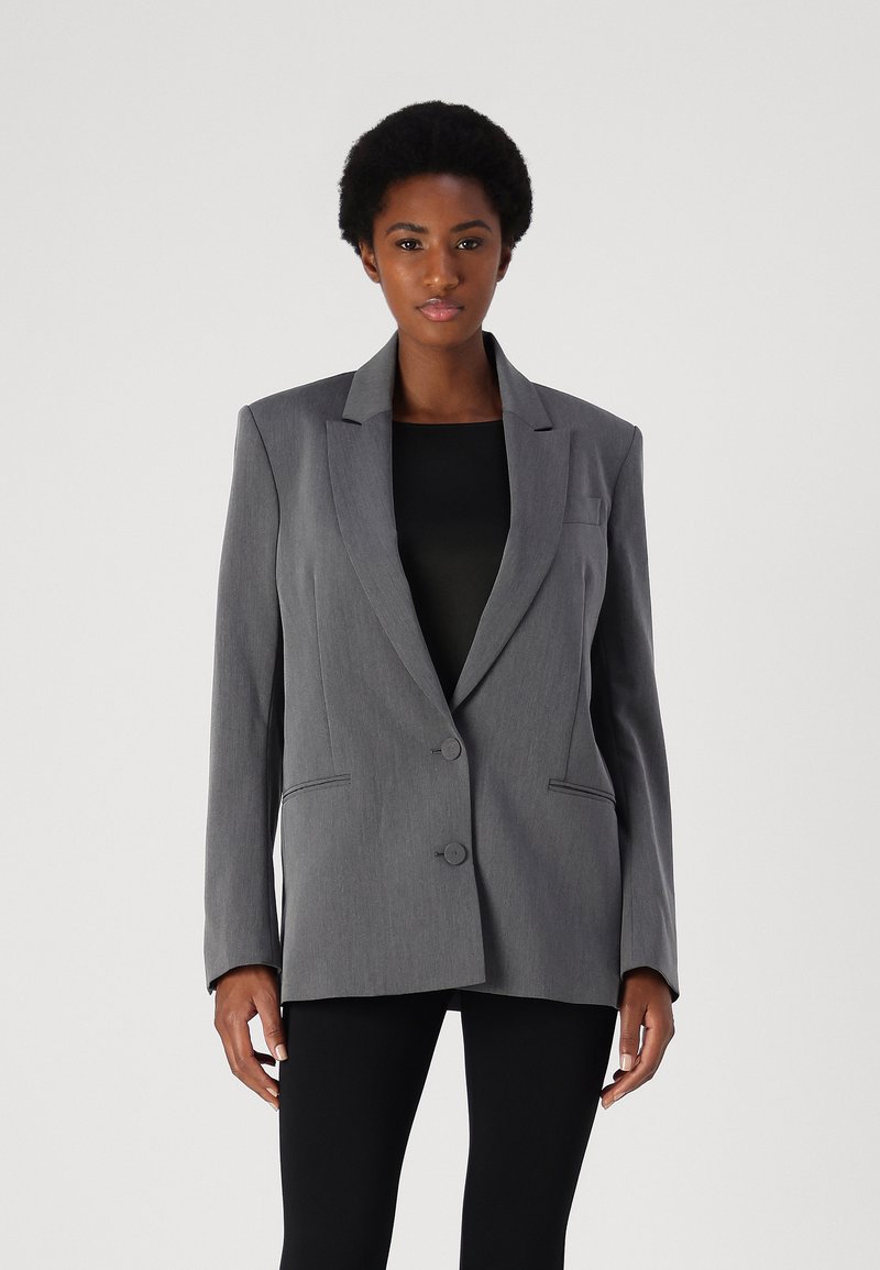 Gray tailored blazer with notch lapels, two buttons, and front pockets. Made from textured fabric, features clean lines and structured shape.