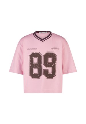 Pink short-sleeve shirt with dark striped V-neck, large distressed "89" number, "COME AS YOU ARE" text, and small "New York Club" logo on front.