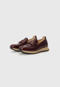Burgundy leather slip-on shoes with a textured finish, featuring a stitched band and a light rubber sole for traction.